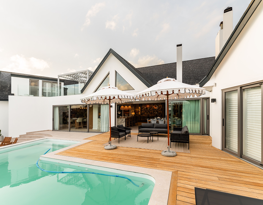 Pool deck with a cream umbrella